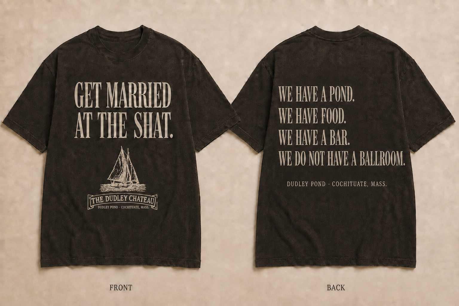 Front and back of a washed dark brown T-shirt: the front reads Get Married at the Shat with the Dudley Chateau schooner logo; the back reads We have a pond. We have food. We have a bar. We do not have a ballroom.